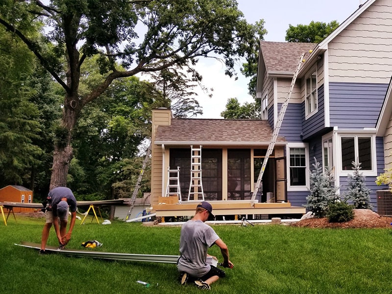 the kingdom builders gutter installation team working on ground