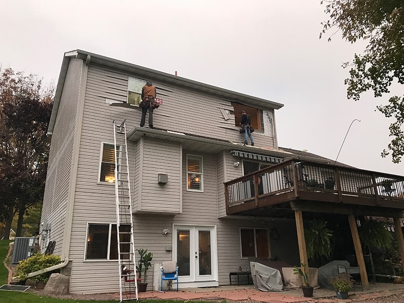 team installing windows on three story home