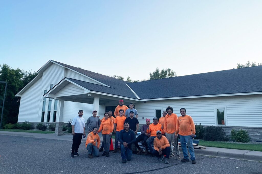 the kingdom builders roofing team posing after project