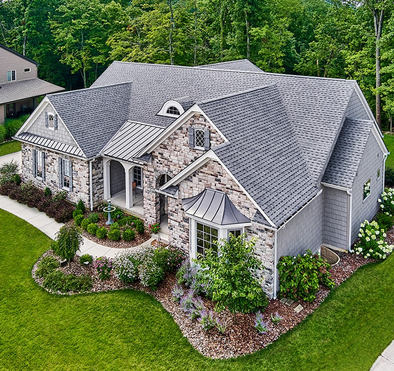 Atlas Pinnacle Pristine in pewter on stone covered home