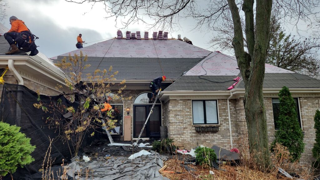 Roofing crew up on the roof of the house in Minnetonka.