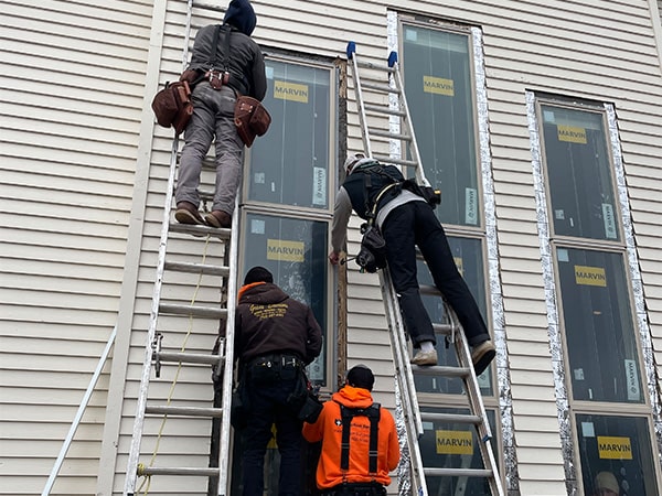 four installers putting in 12 foot window