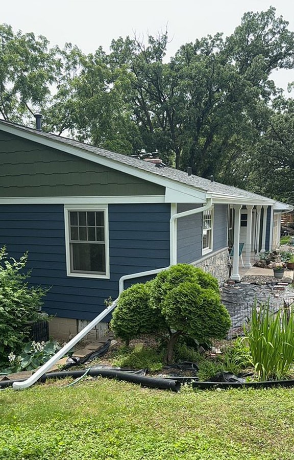 side view of completed roofing and siding on rambler in minnetonka