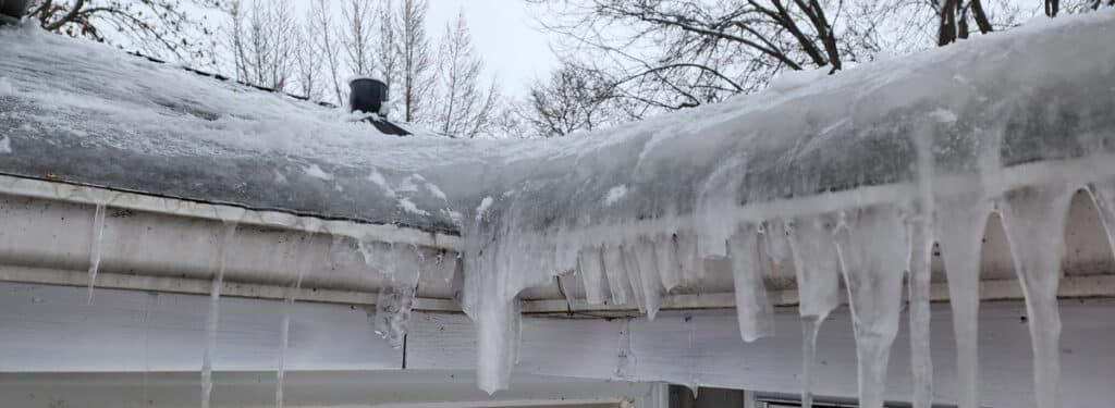 Ice dam on the eave of a house about 6 inches thick