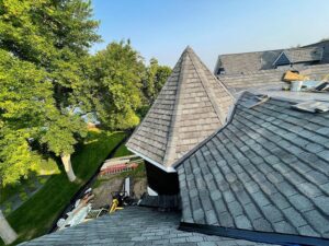 new shingles installed on roof with turret