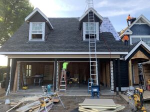 roof installers working alongside other contractors on job site