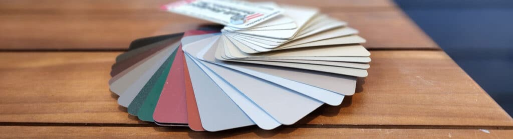 Seamless Gutter Color fan spread out showing the many colors available on a table