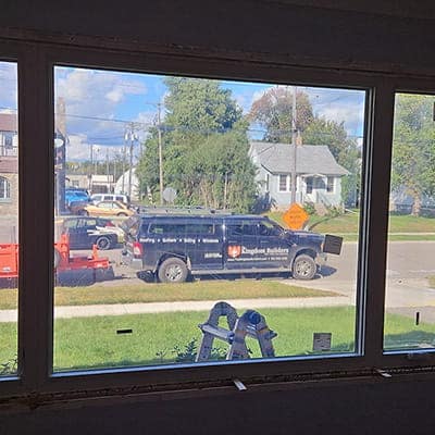 the kingdom builders truck visible through installed picture window in living room