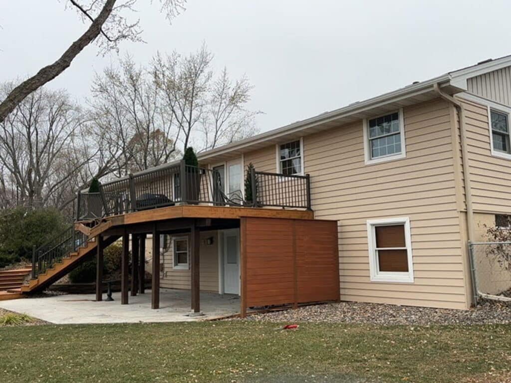 Back elevation of a Maple Grove rambler with newly installed gutters and downspouts