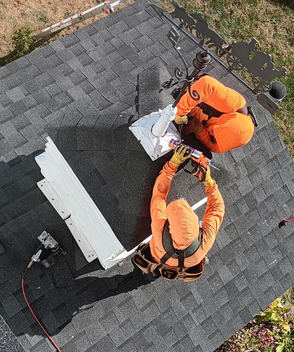 two tkb employees fixing roof