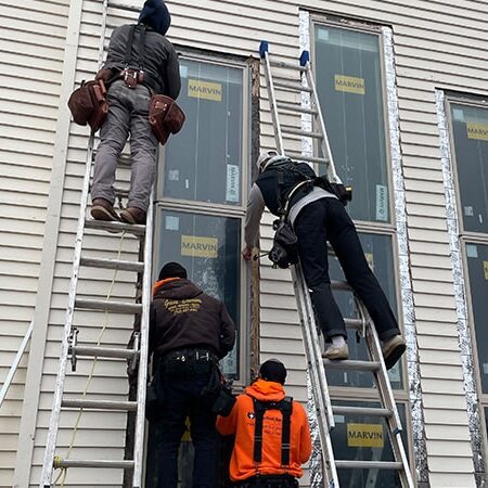 four installers putting in 12 foot window